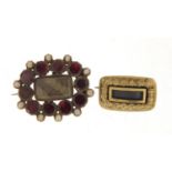 Two Georgian gold coloured metal mourning brooches including one set with garnets and seed pearls,