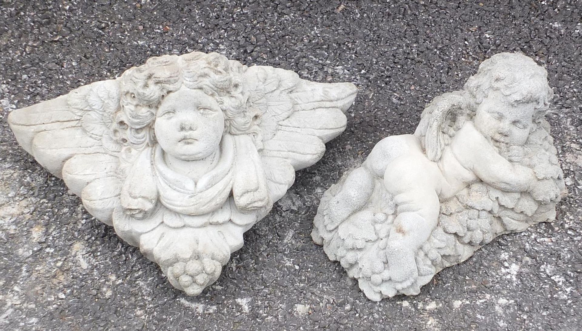 Stoneware garden figure of Putti and a wall pocket, the largest 38cm wide :
