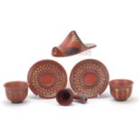 Turkish Tophane terracotta comprising a slipper, two tea bowls with saucers and a pipe bowl, the
