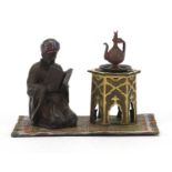 Cold painted bronze figure of an Arab on carpet in the style of Franz Xaver Bergmann, 14cm wide :