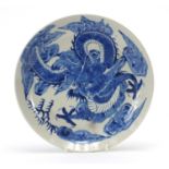 Chinese blue and white porcelain plate hand painted with a dragon amongst clouds chasing a flaming