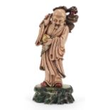 Large Chinese pink soapstone carving of Shou Lao holding a basket and peach, 30cm high :