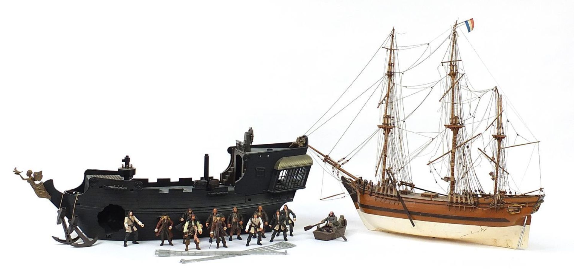 Wooden model boat and a Pirates of the Caribbean boat with action figures, the largest 88cm in