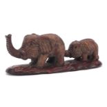 Japanese carved wood okimono of two elephants, inset mother of pearl plaque with character marks