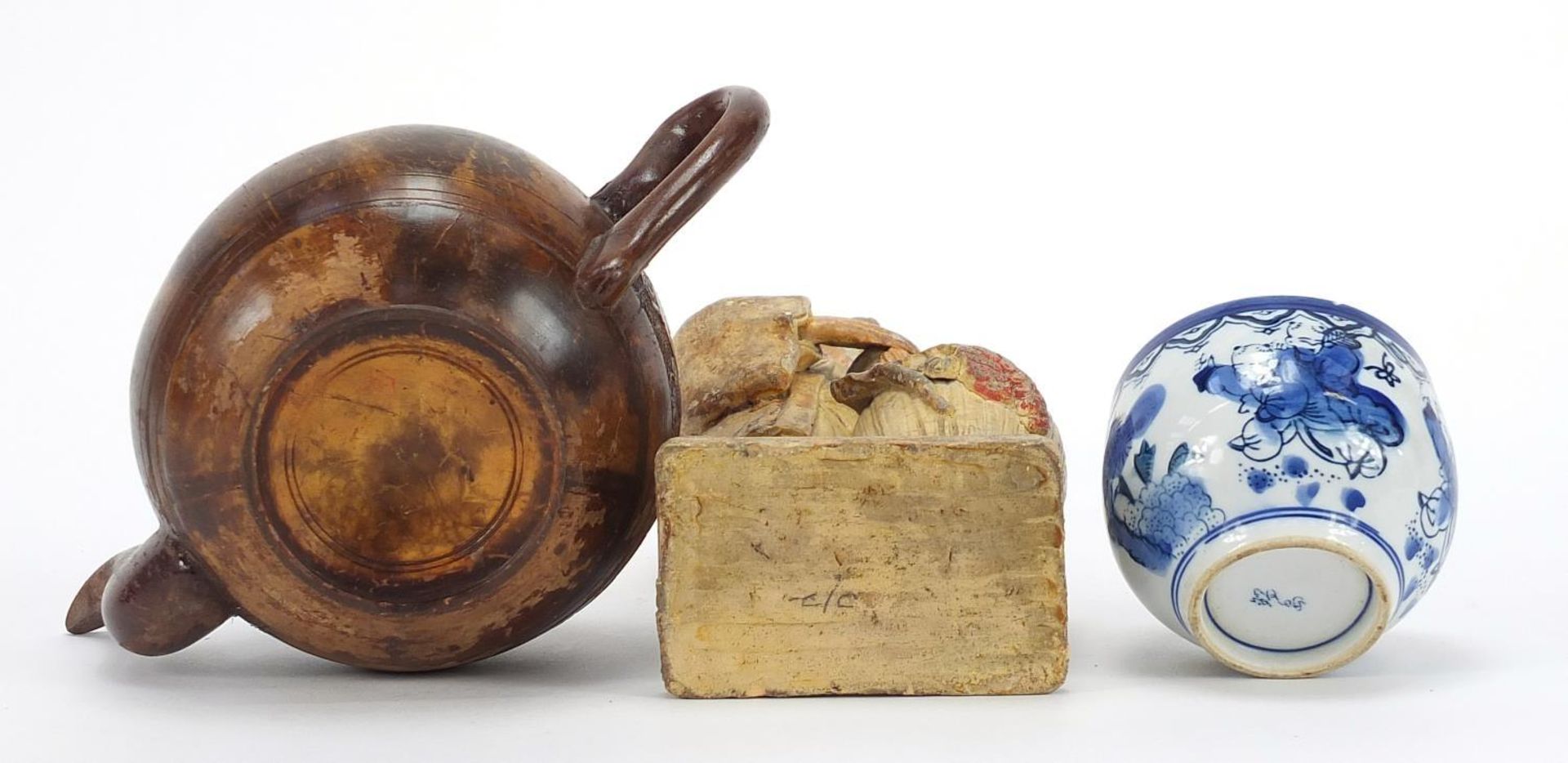 Oriental objects including a carved wood teapot and pottery figure of a man holding a peach, the - Image 8 of 9