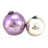 Two large Victorian mirrored glass witches balls including a mauve example, the largest
