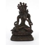 Chino Tibetan bronze figure of Buddha with remnants of gilding and red paint, 15cm high :
