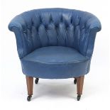 Mahogany framed tub chair with blue button back upholstery on brass casters, 70cm high