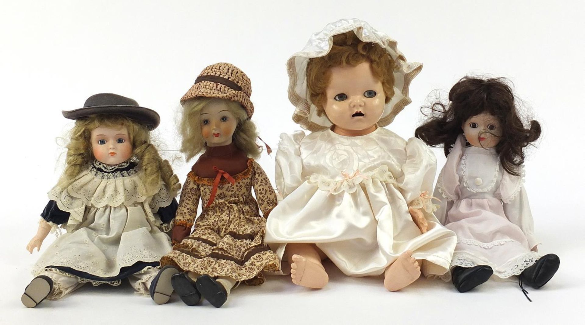 Four vintage and later dolls including three with porcelain heads :