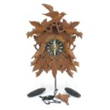 Carved Black Forest cuckoo clock with weights and pendulum, 37cm high :