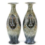 Royal Doulton, pair of Art Nouveau stoneware vases decorated with stylised flowers, each 32cm high :