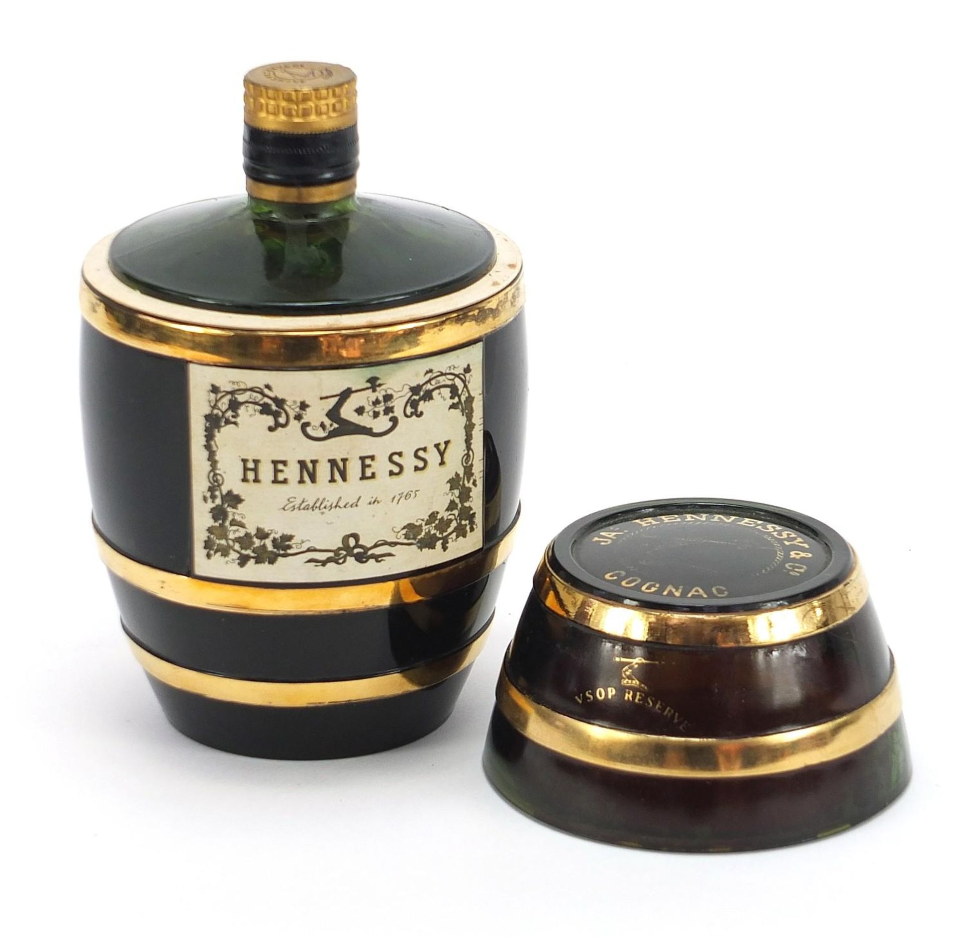 Bottle of Hennessey cognac housed in a barrel design glass bottle, 19cm high :