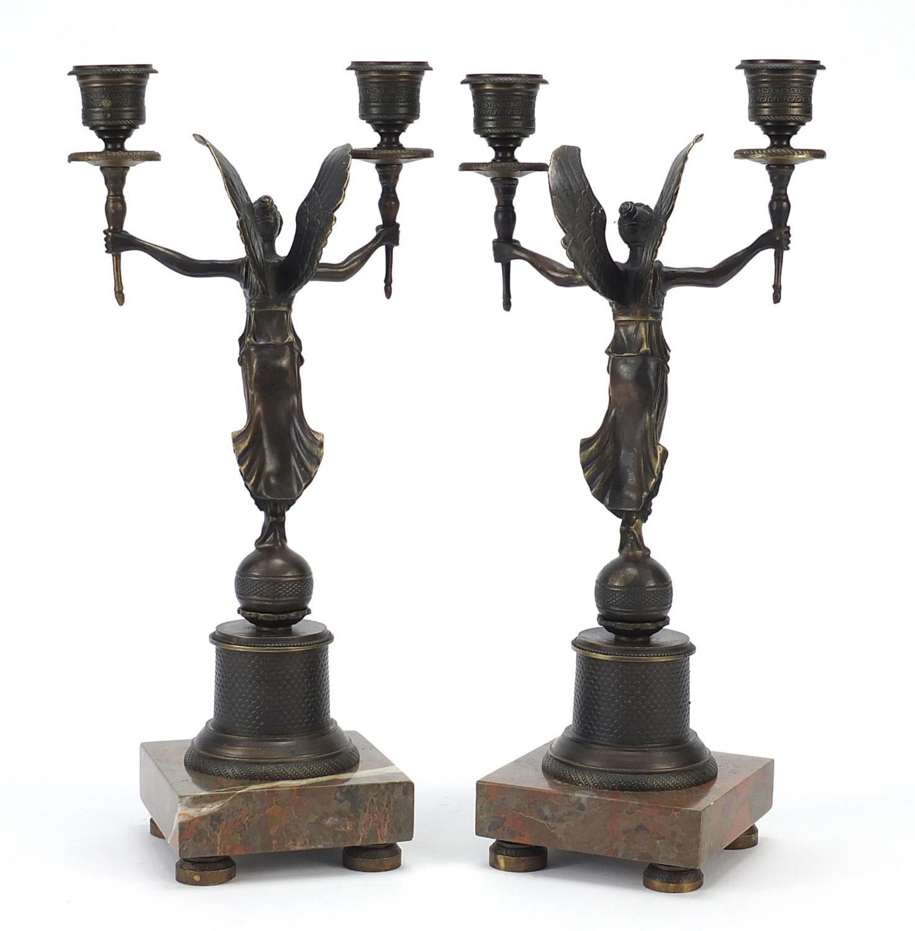Pair of classical patinated bronze figural two branch candlesticks raised on square marble bases, - Image 3 of 4