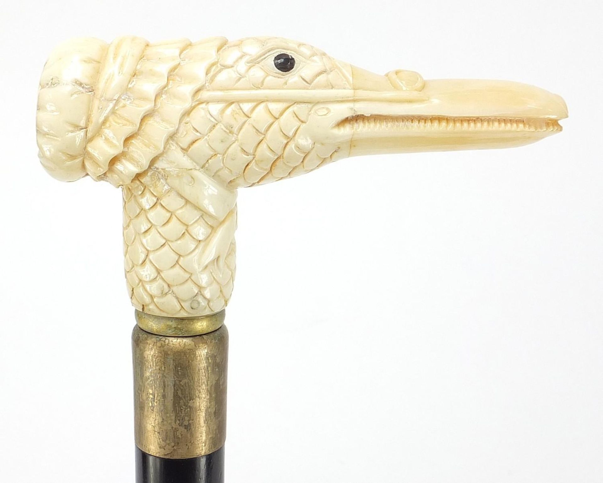 Hardwood walking stick with carved bone duck design handle, 91.5cm in length :