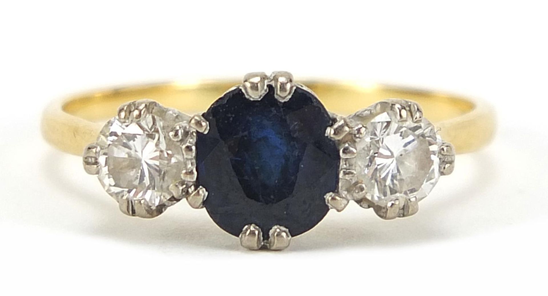 Unmarked gold, sapphire and diamond three stone ring, the sapphire approximately 7mm x 6mm, the