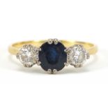 Unmarked gold, sapphire and diamond three stone ring, the sapphire approximately 7mm x 6mm, the