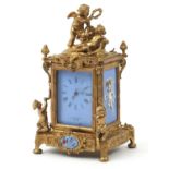 Continental gilt bronze mantle clock with porcelain panels decorated with Putti, 29.5cm high :