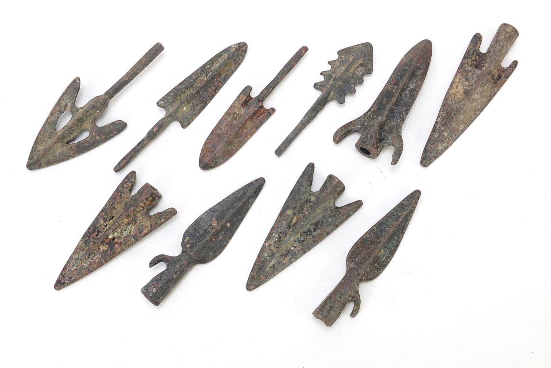 Ten patinated bronze arrow heads, the largest approximately 8cm in length :