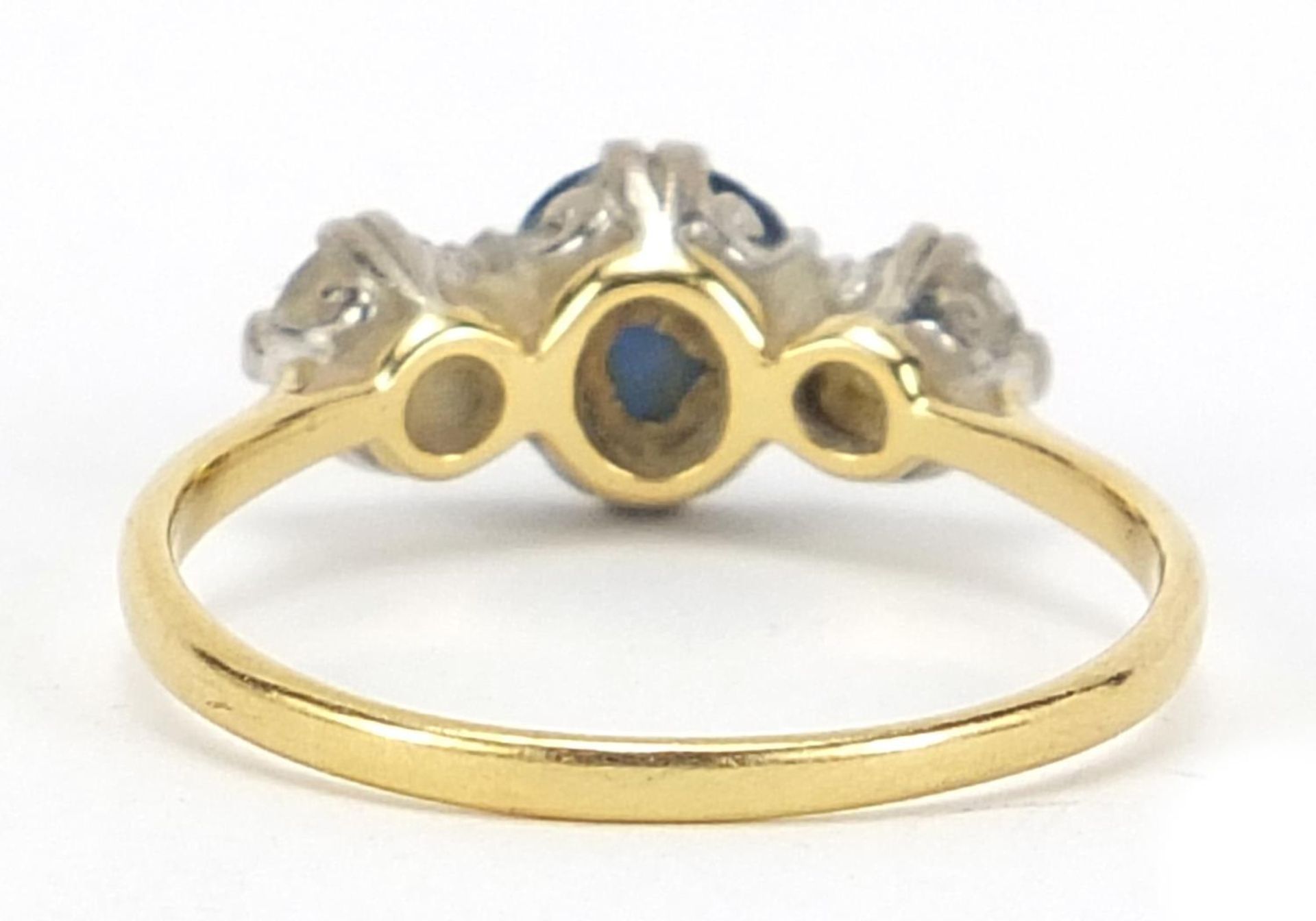 Unmarked gold, sapphire and diamond three stone ring, the sapphire approximately 7mm x 6mm, the - Image 4 of 4