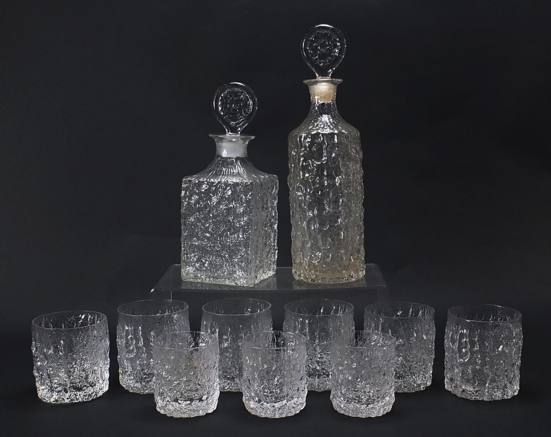 Geoffrey Baxter for Whitefriars, textured glassware comprising two decanters, set of six tumbles and