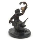 Cold painted bronze figure of Putti on a swan raised on an oval slate base, 11cm high :