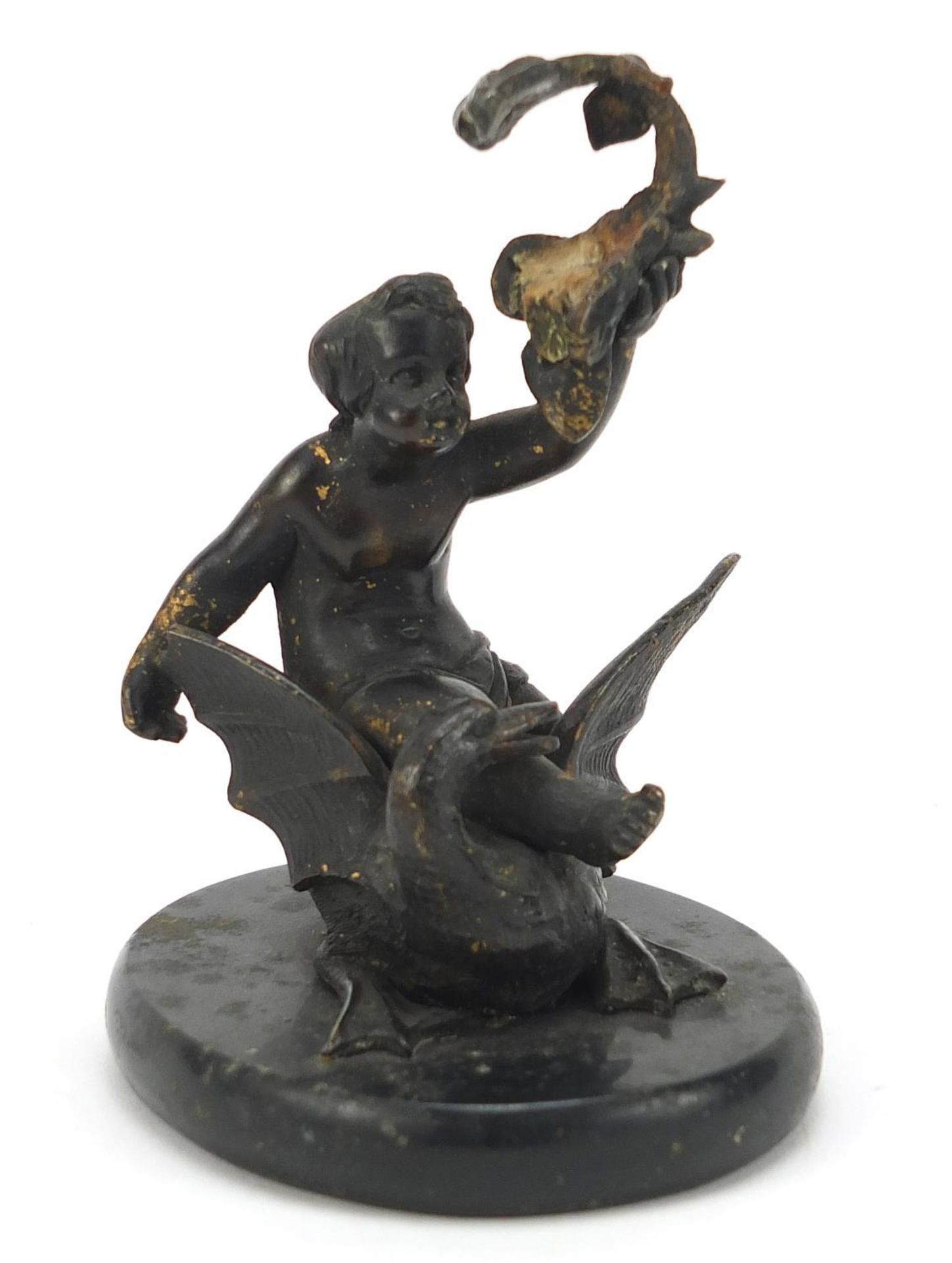 Cold painted bronze figure of Putti on a swan raised on an oval slate base, 11cm high :