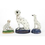 Two Staffordshire pottery Dalmatians and one other, the largest 13cm high :