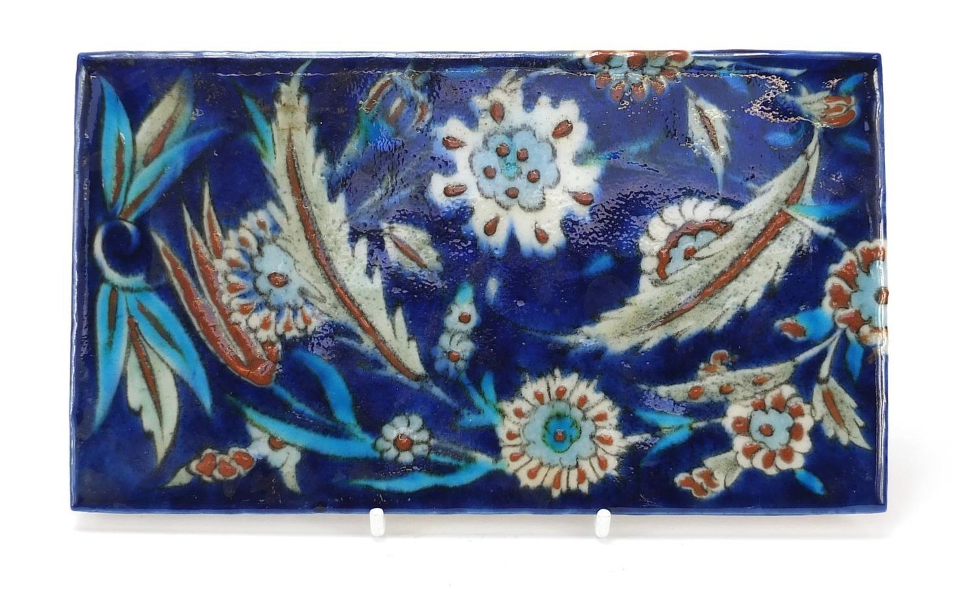 Turkish Iznik tile fragment hand painted with flowers and foliage, 21cm x 12cm :