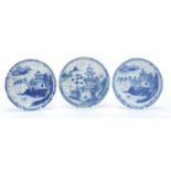 Three Chinese blue and white porcelain dishes each hand painted with a pagoda and river landscape,