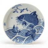 Chinese blue and white porcelain footed dish hand painted with fish amongst waves, six figure