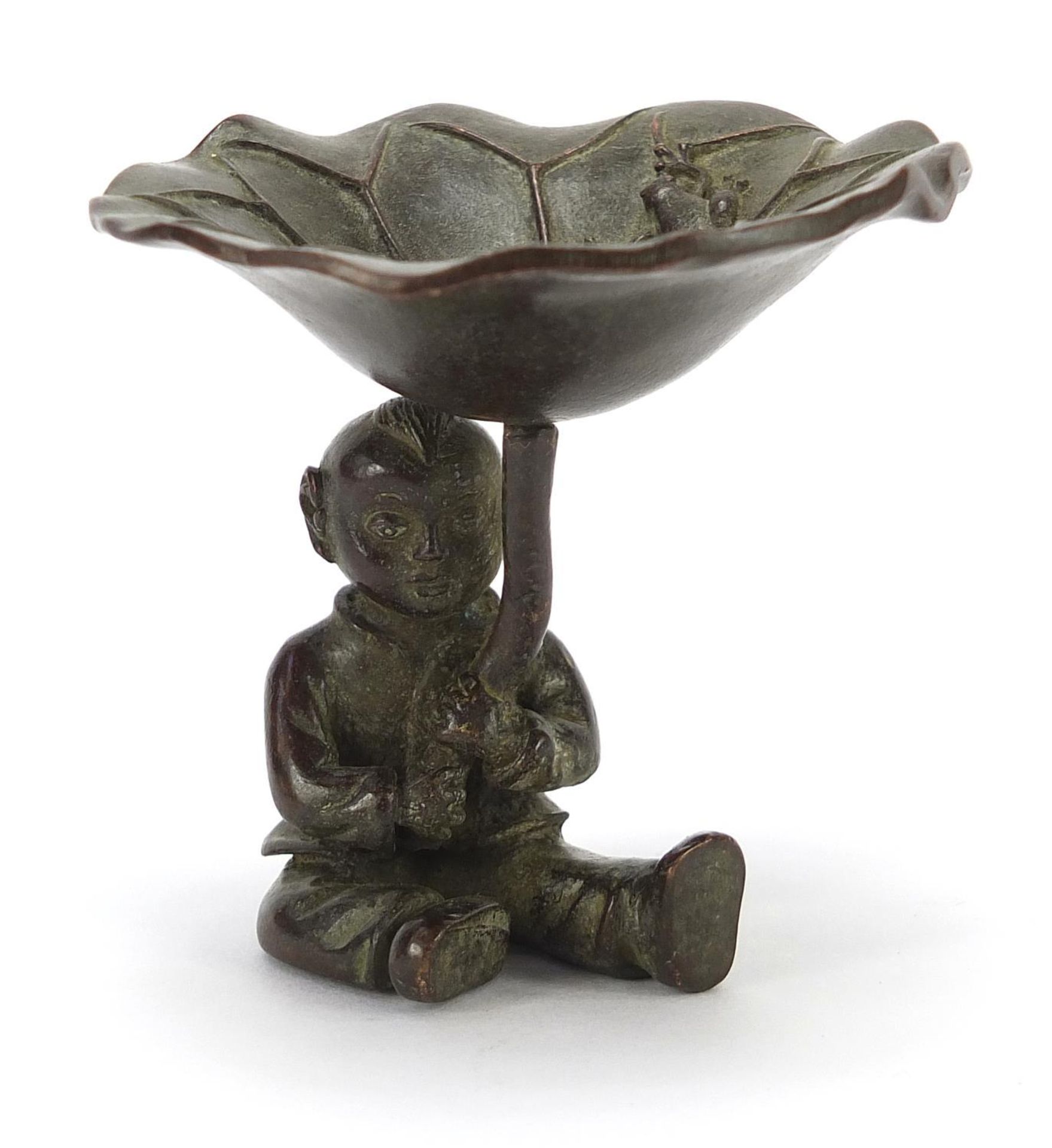 Chinese patinated bronze figure of a young boy holding a plant, 6cm high :