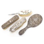 Silver vanity items including an enamelled brush, Art Nouveau backed brush and large hand mirror