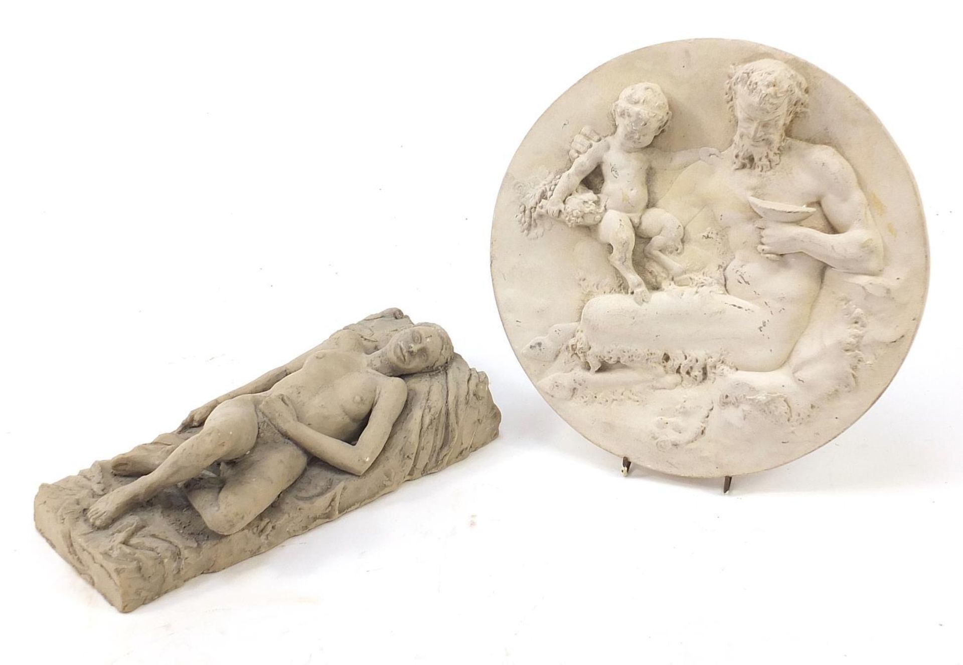 Modernist sculpture of a reclining nude female and a plaster roundel of a faun, the largest 29cm