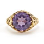 Unmarked gold blue/purple stone ring with ornate pierced setting, possibly alexandrite, the stone