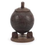 Anglo Indian carved coconut vase and cover with elephant supports, 23cm high :For Further