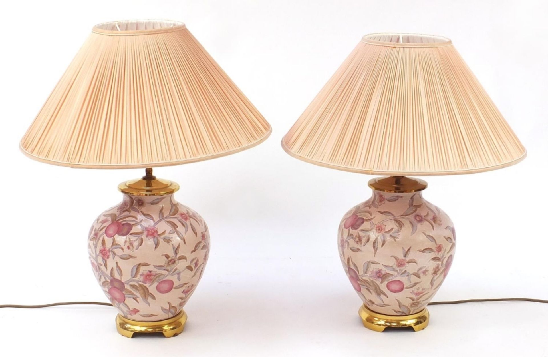 Pair of Chinese porcelain table lamps with shades each hand painted with flowers and plums, each