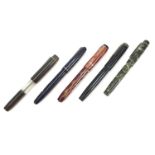 Five vintage fountain pens, four with gold nibs including two marbleised and a Swan self-filler :For