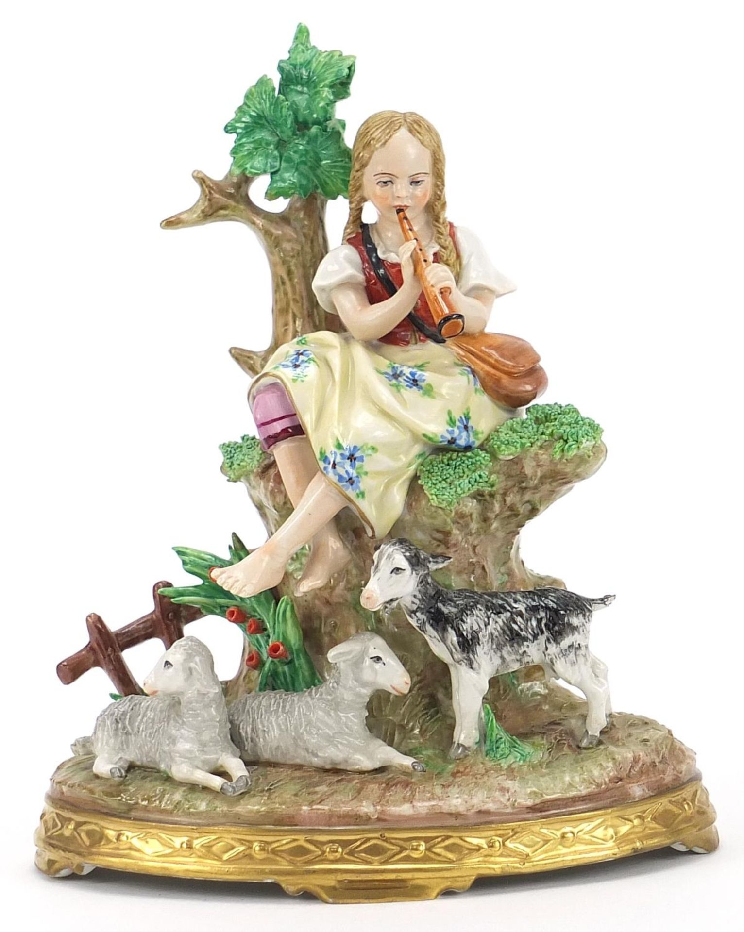 German porcelain figurine of a female playing a flute with a kid and two lambs, 19.5cm high :For