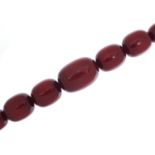 Very large cherry amber coloured bead necklace, the largest bead 4cm in length, 50cm in length,