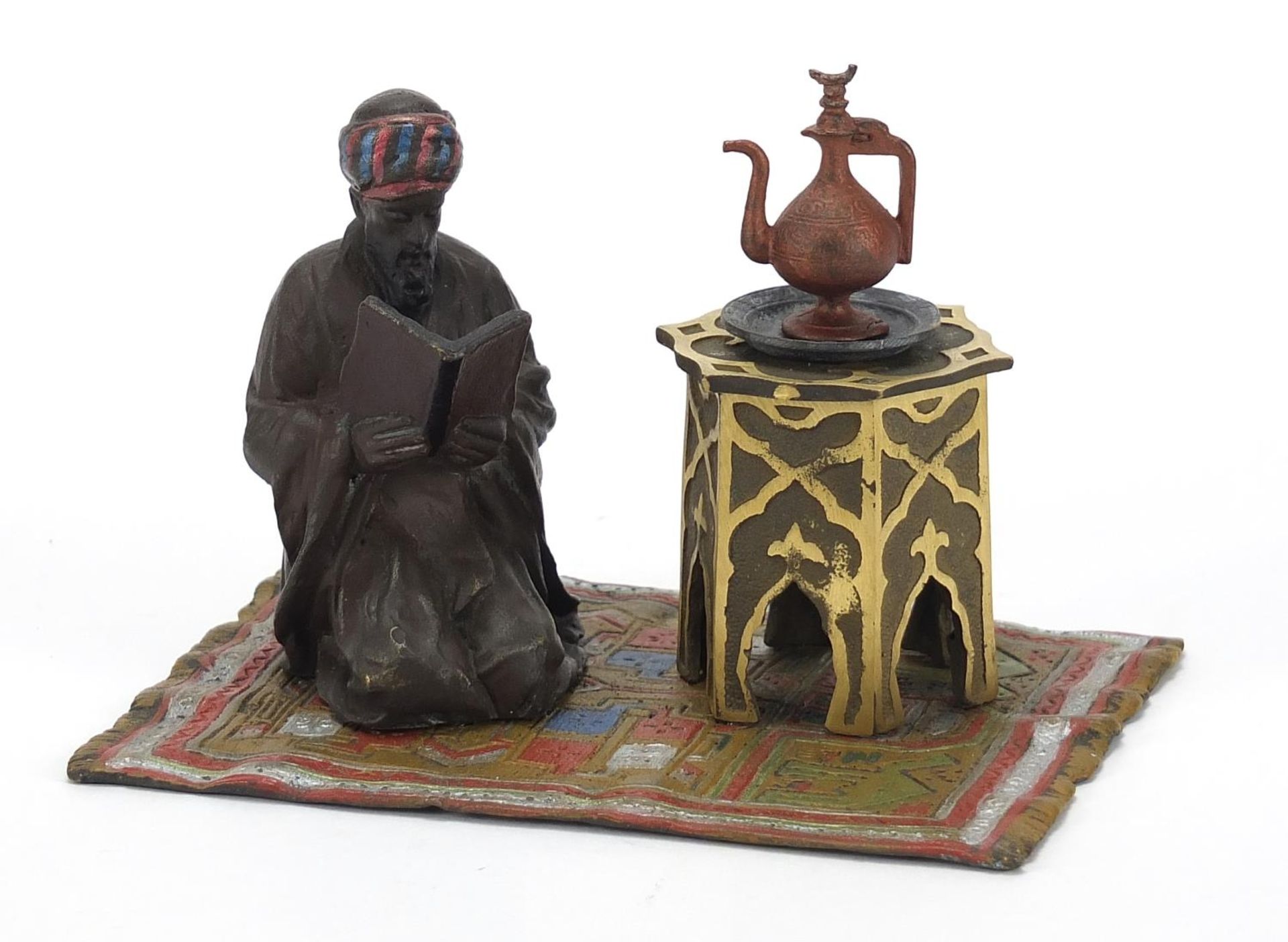 Cold painted bronze of a figure on a carpet in the style of Franz Xaver Bergmann, 14.5cm wide :For