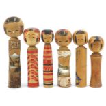 Six Japanese Kokeshi hand painted wood dolls, the largest 29cm high :For Further Condition Reports