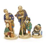 Three Japanese Satsuma pottery figures including two of a father with child, the largest 18.5cm high