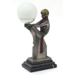 Art Deco design desk lamp in the form of a scantily dressed female with globular glass shade, raised