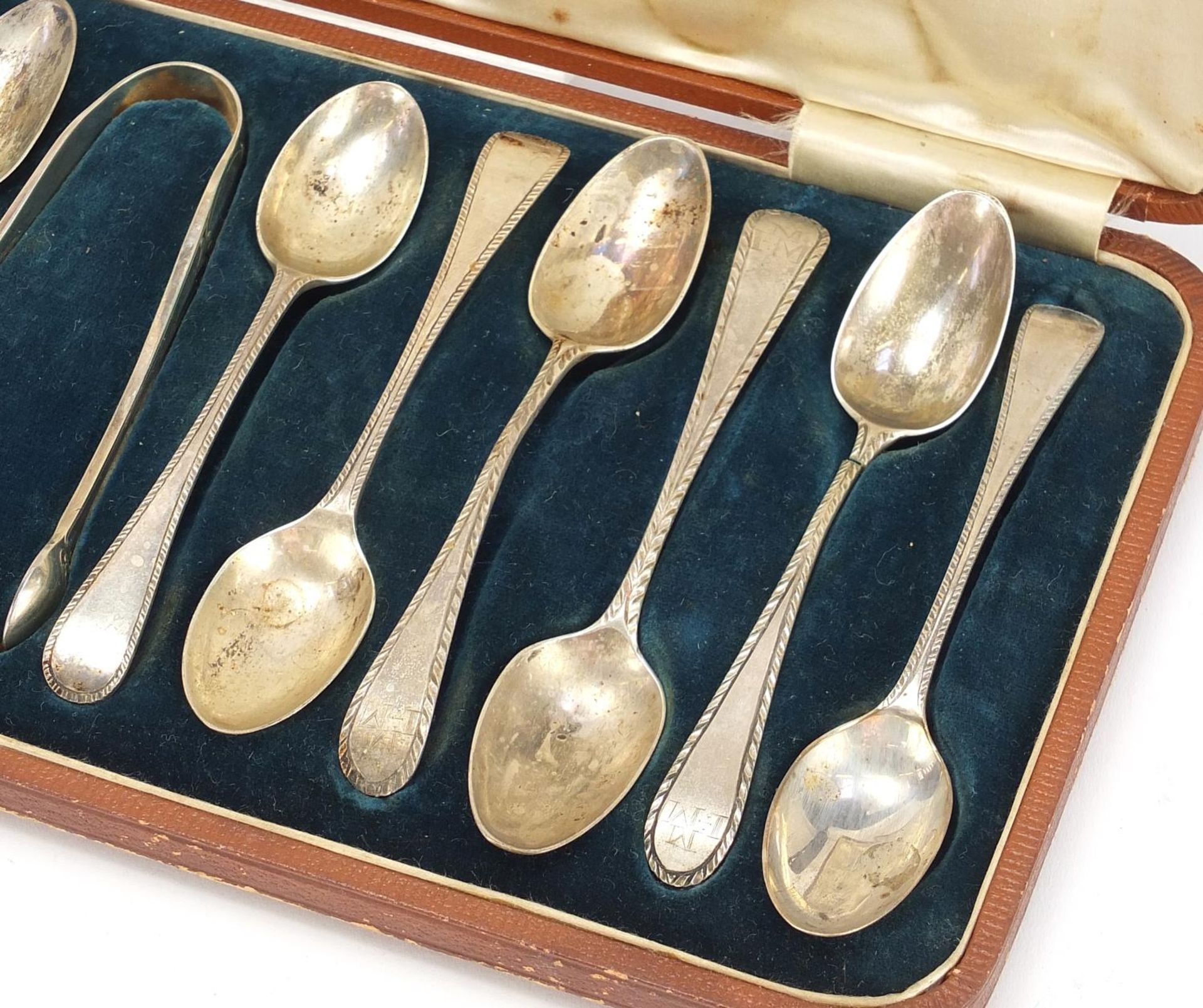 Matched set of twelve silver teaspoons and silver plated sugar tongs housed in a velvet and silk - Image 3 of 6