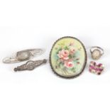 Four silver brooches and a ring, including painted porcelain brooch by Avis M Miles and a silver and