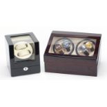 Two electric watch display cases including one housing four gentlemen's wristwatches comprising
