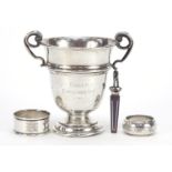 Golfing interest silver trophy with twin handles, two silver napkin rings and a bookmark, the trophy