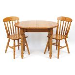 Pine oval extending dining table with two chairs, 75.5cm H x 102cm W x 79cm D when closed, each