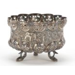 Burmese unmarked silver bowl, pierced and embossed with figures hunting wild animals and raised on
