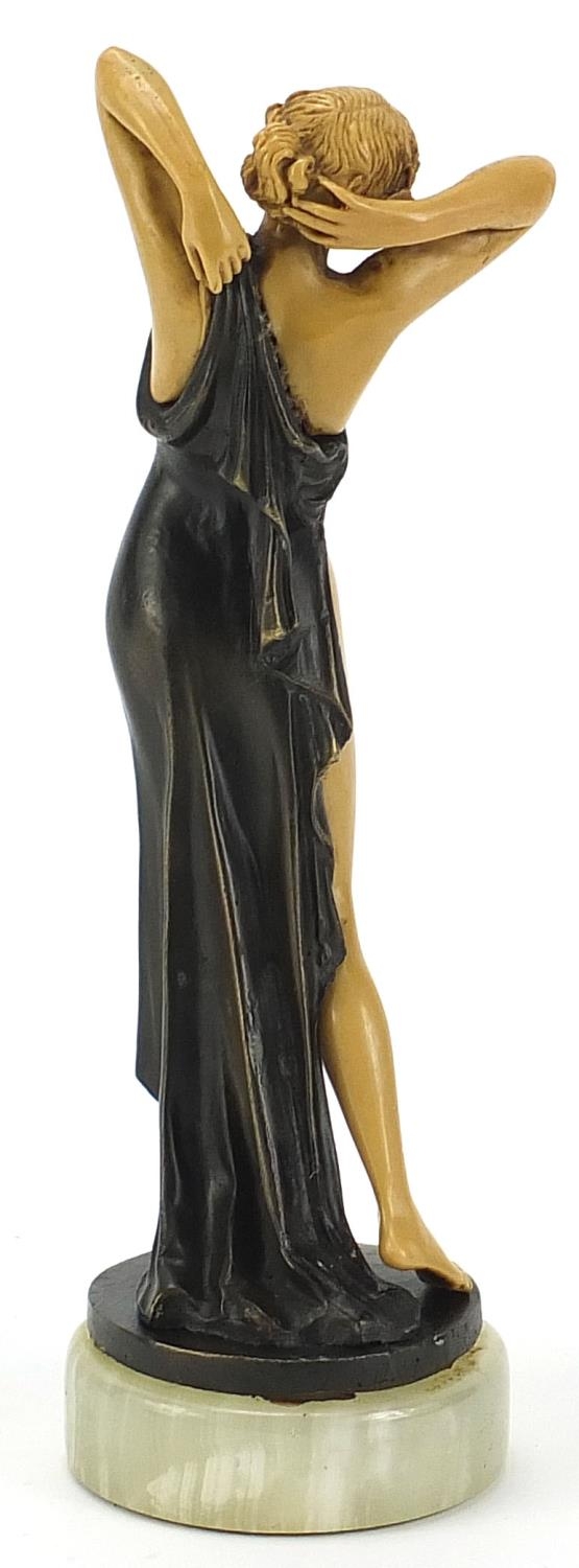 Art Deco style bronzed and ivorine figurine of a scantily dressed female raised on a circular onyx - Image 2 of 3